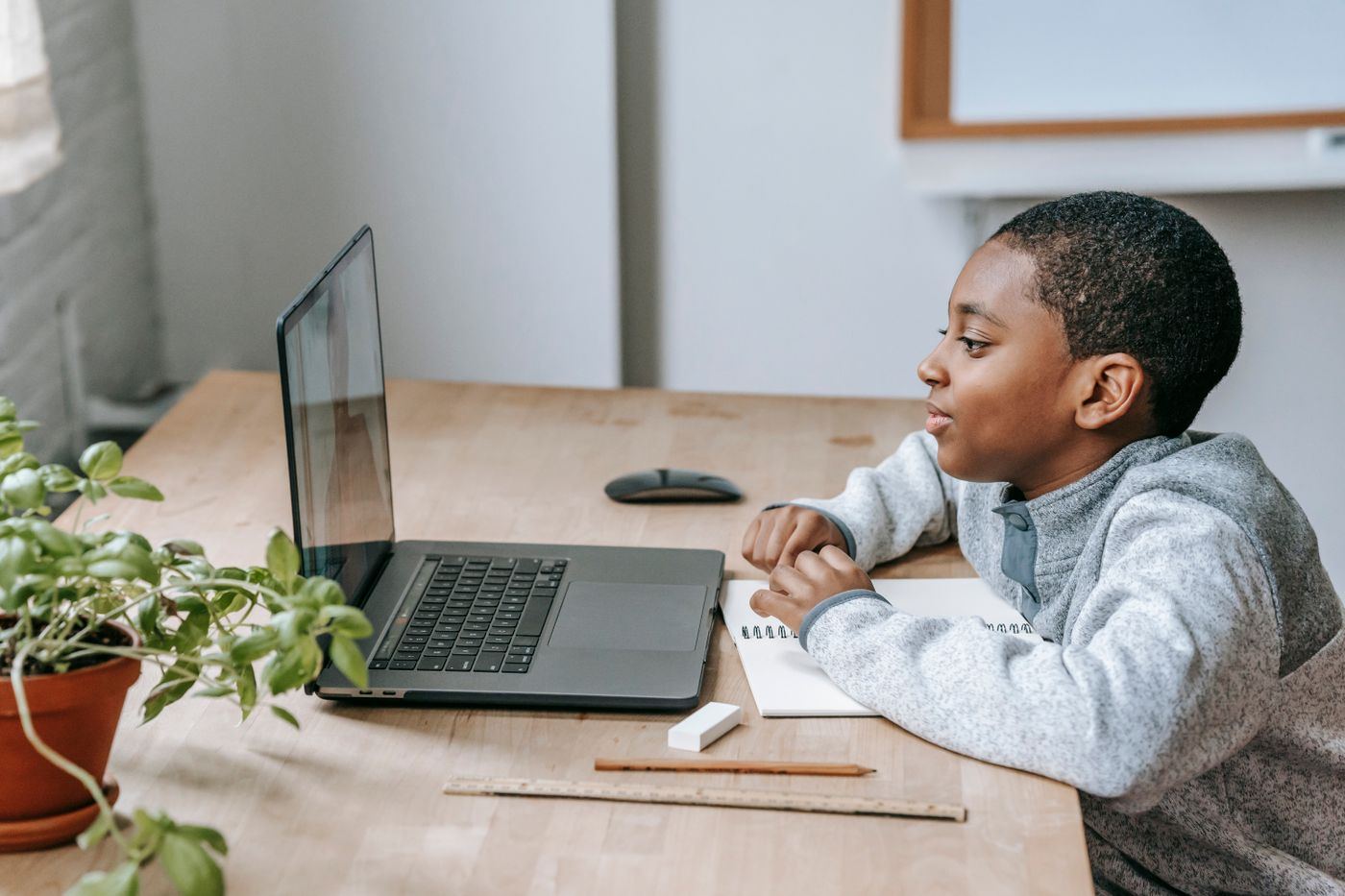 A learner watching a lesson video on a laptop